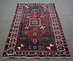 Vintage Persian Shiraz rug 145x207 cm full view showing geometric tribal motifs on deep red field
