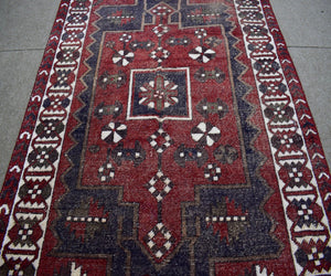 Vintage Shiraz Persian rug with large central medallion and stepped geometric tribal pattern
