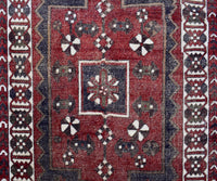 Close-up of vintage Persian Shiraz rug showing detailed central medallion and ivory geometric accents
