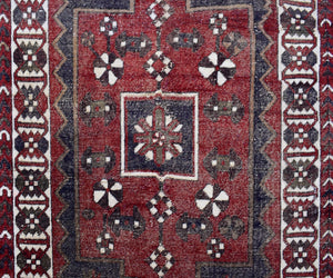 Close-up of vintage Persian Shiraz rug showing detailed central medallion and ivory geometric accents

