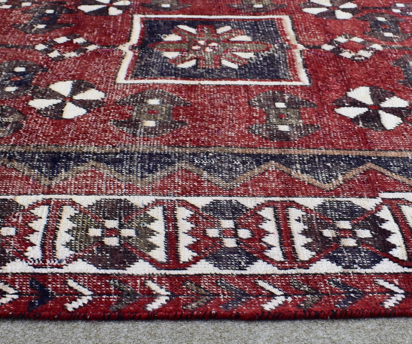 Traditional Shiraz Persian rug border detail with bold tribal guard stripes in red, navy and ivory
