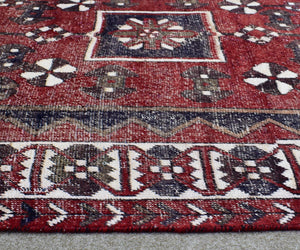 Traditional Shiraz Persian rug border detail with bold tribal guard stripes in red, navy and ivory
