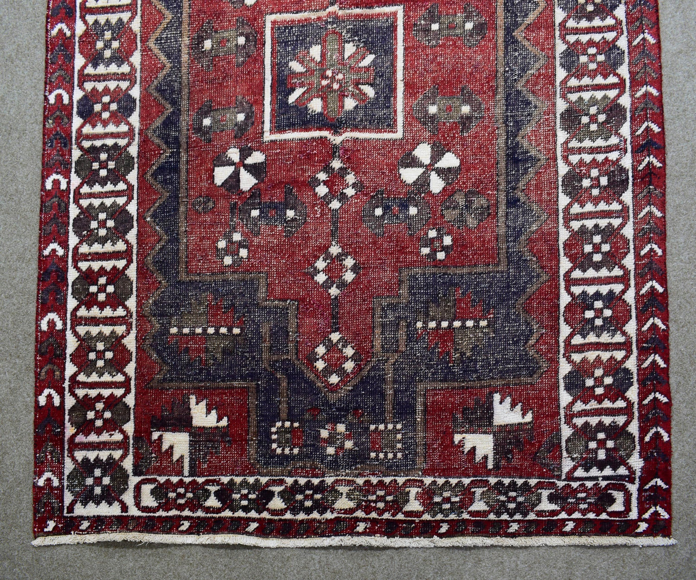 Detailed view of Shiraz rug field with stylized tribal motifs and rich red wool texture
