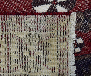 Backside of hand knotted vintage Persian Shiraz rug showing authentic weaving structure and natural wool foundation
