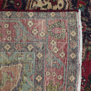Backside of hand knotted Persian Shiraz rug showing weave density and traditional wool foundation