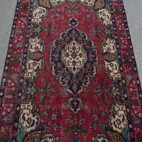 Close-up of central medallion on vintage Persian Shiraz rug with navy, ivory and red detailing
