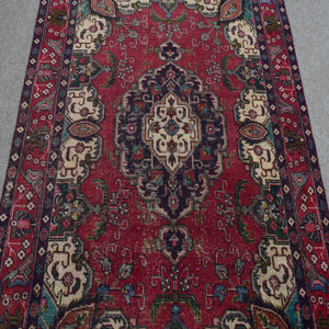 Close-up of central medallion on vintage Persian Shiraz rug with navy, ivory and red detailing