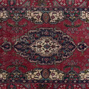Detailed view of Shiraz rug midsection showing intricate geometric floral pattern on red field