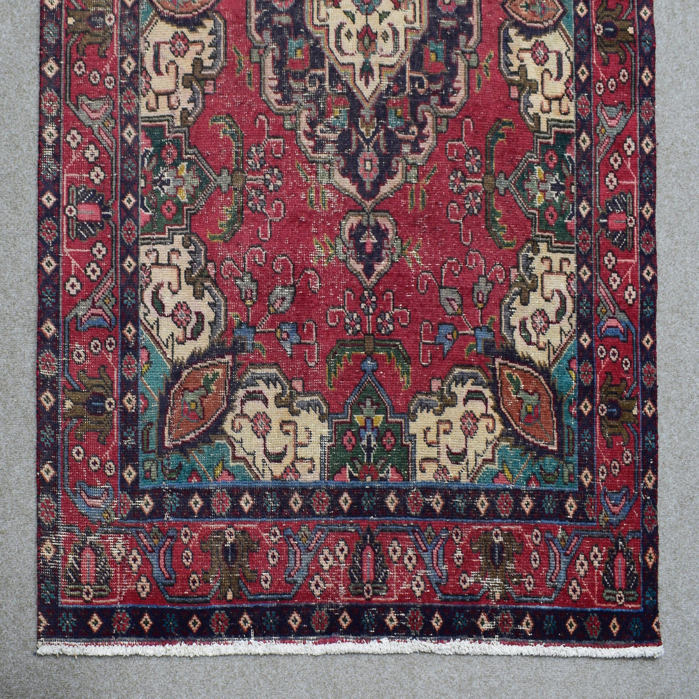 Border detail of hand knotted Shiraz rug with layered guard stripes and contrasting accents