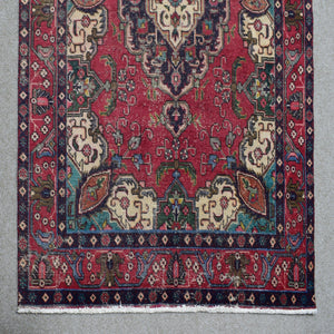 Border detail of hand knotted Shiraz rug with layered guard stripes and contrasting accents