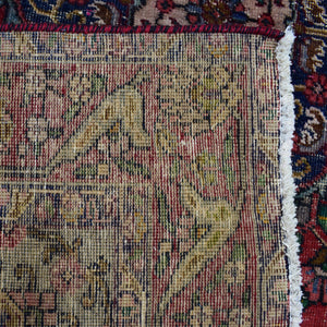 Backside of hand knotted Shiraz rug showing weave density and traditional wool foundation
