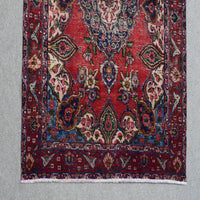 Border detail of Persian Shiraz rug featuring layered guard stripes and multicolored geometric patterns