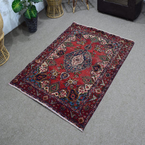 Angled perspective of vintage Shiraz rug highlighting rich red tones and intricate floral motifs