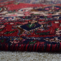 Low angle close-up of Shiraz rug pile showing thick wool texture and vibrant color contrast