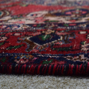 Low angle close-up of Shiraz rug pile showing thick wool texture and vibrant color contrast
