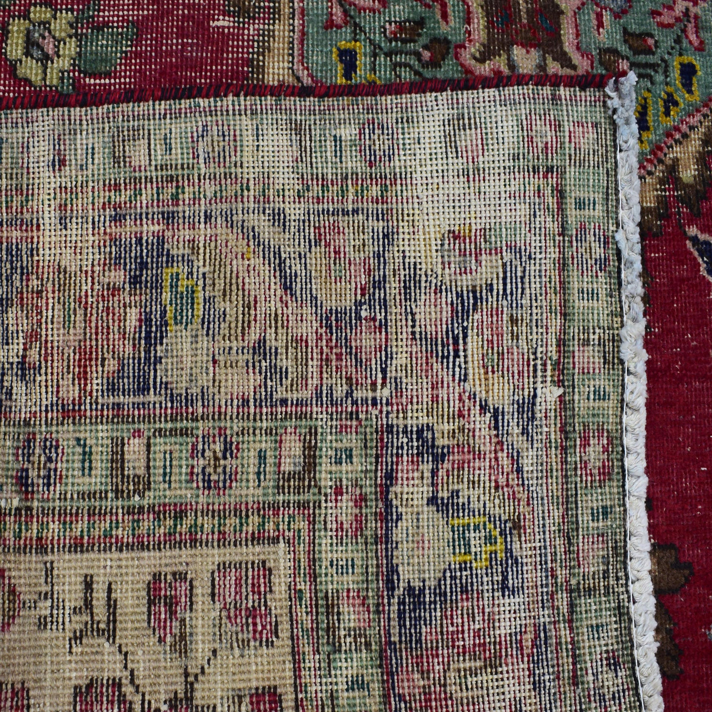 Backside of hand knotted Shiraz rug showing weave density and traditional wool foundation