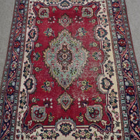Close-up of central medallion on Shiraz rug with mint green, ivory and navy detailing