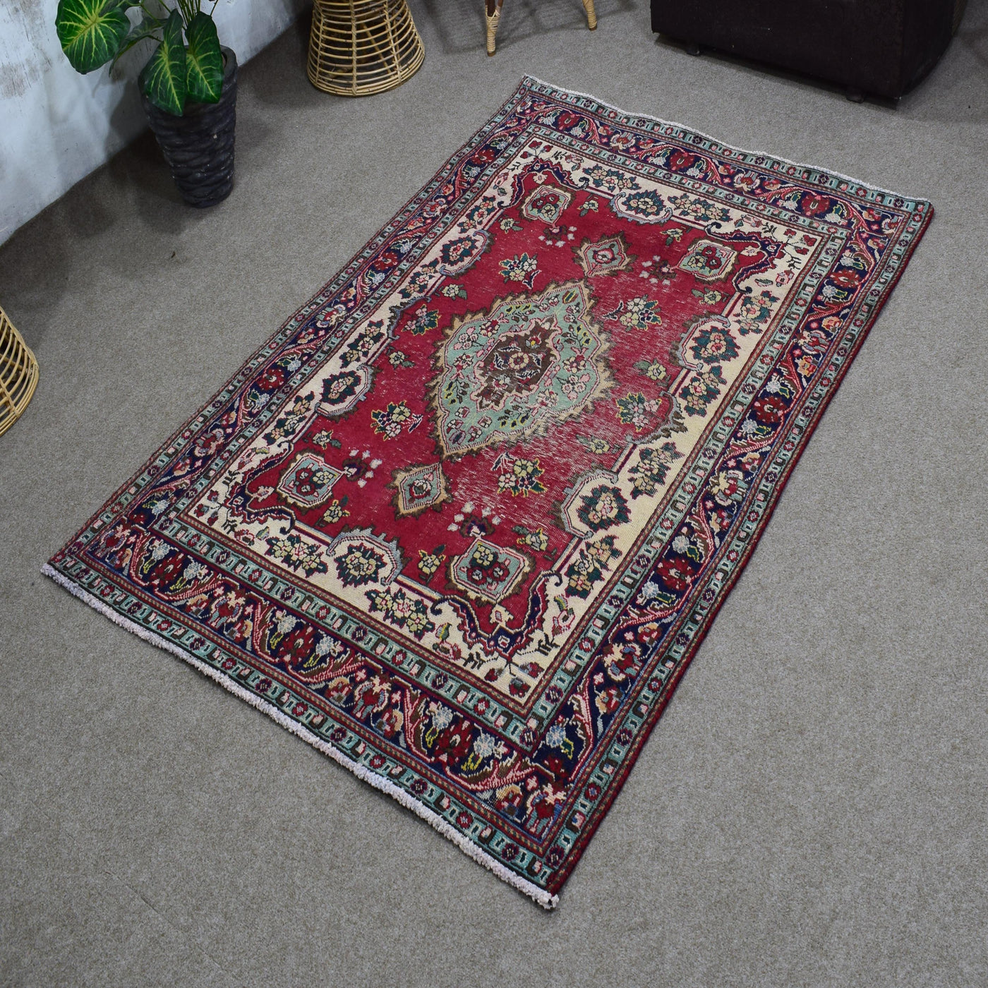 Angled perspective of vintage Shiraz rug highlighting geometric medallion and vibrant red field