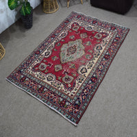 Angled perspective of vintage Shiraz rug highlighting geometric medallion and vibrant red field
