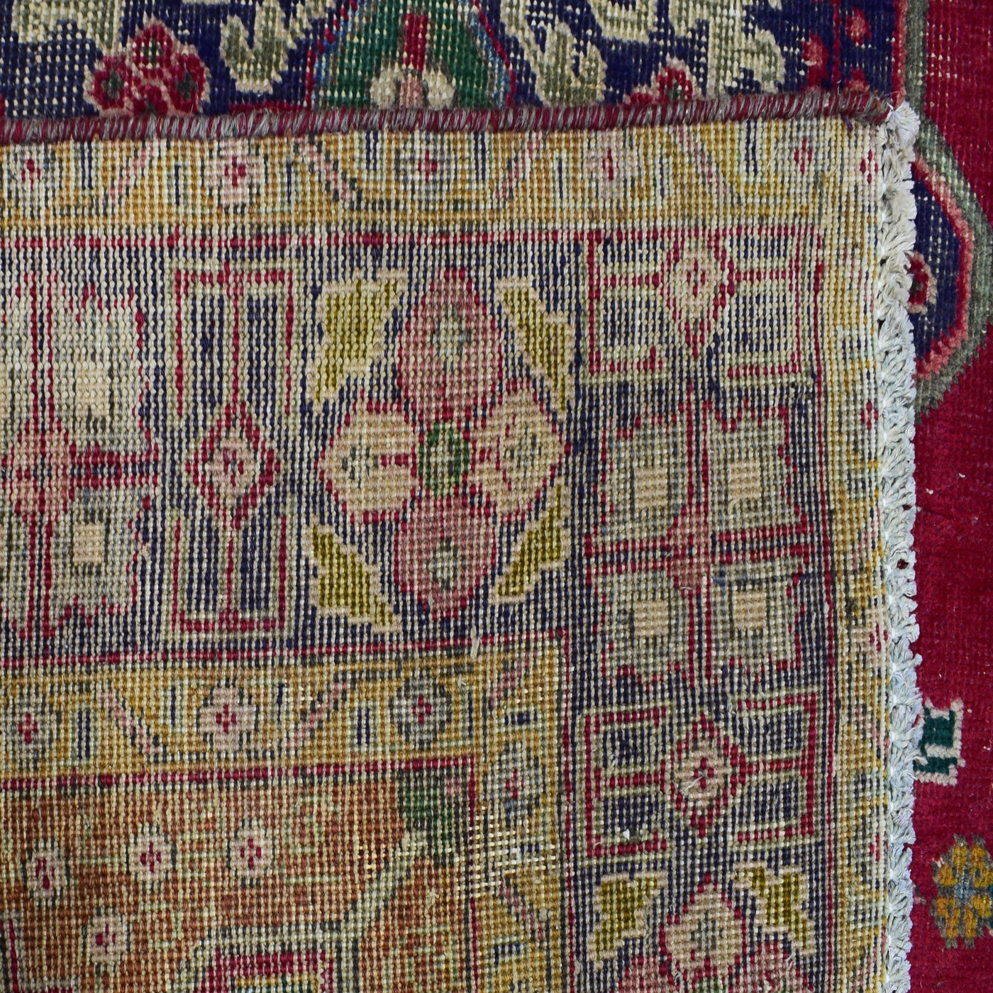 Backside of hand knotted Shiraz rug showing fine weave structure and traditional wool foundation