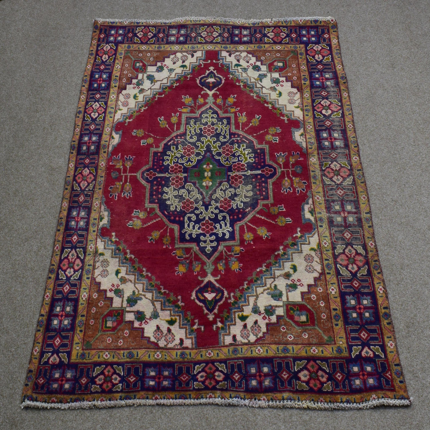 Full length view of Shiraz rug 133x190 cm showing bold central medallion and ivory corner spandrels