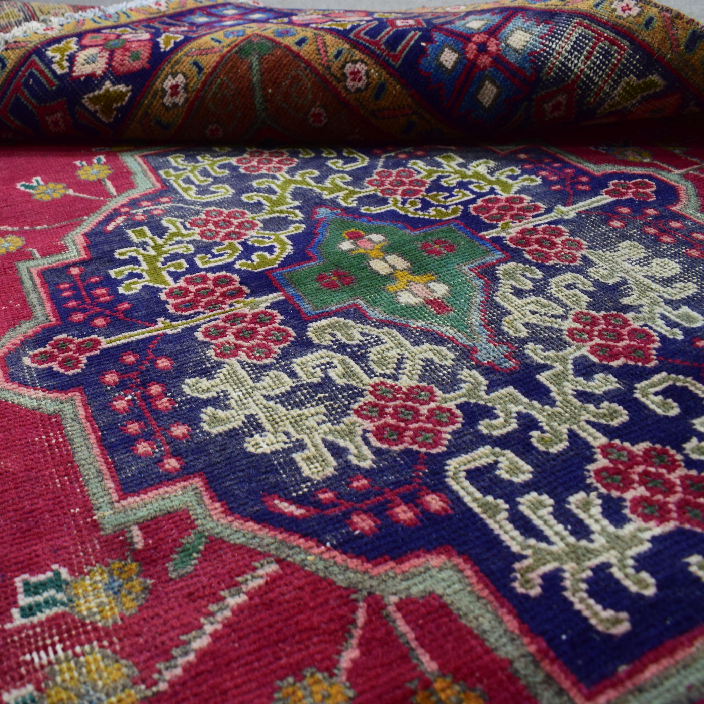 Corner close-up of Shiraz rug highlighting navy field accents and floral design elements