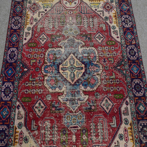 Close-up of Shiraz rug center highlighting geometric medallion in ivory, blue and soft red tones