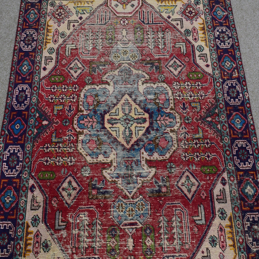 Close-up of Shiraz rug center highlighting geometric medallion in ivory, blue and soft red tones