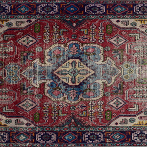 Detailed view of red field with tribal motifs and stepped diamond shapes