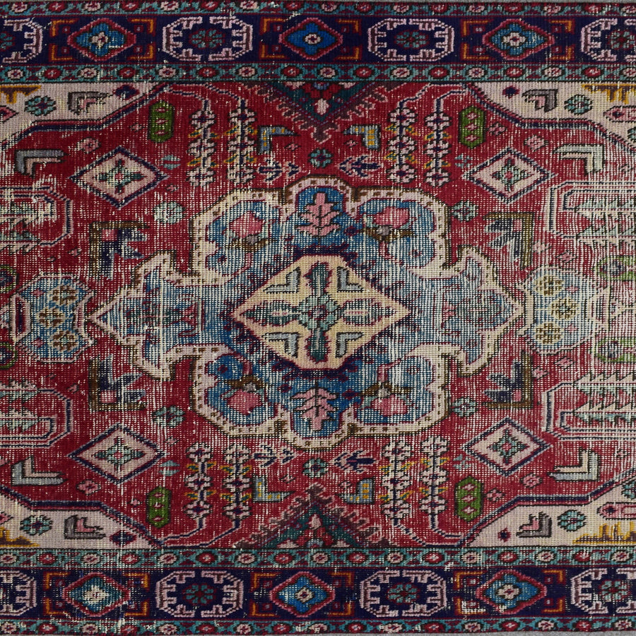 Detailed view of red field with tribal motifs and stepped diamond shapes