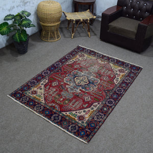 Angled room view of vintage Shiraz rug displaying full proportions and border design