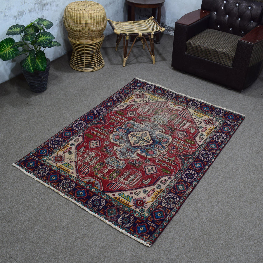 Angled room view of vintage Shiraz rug displaying full proportions and border design