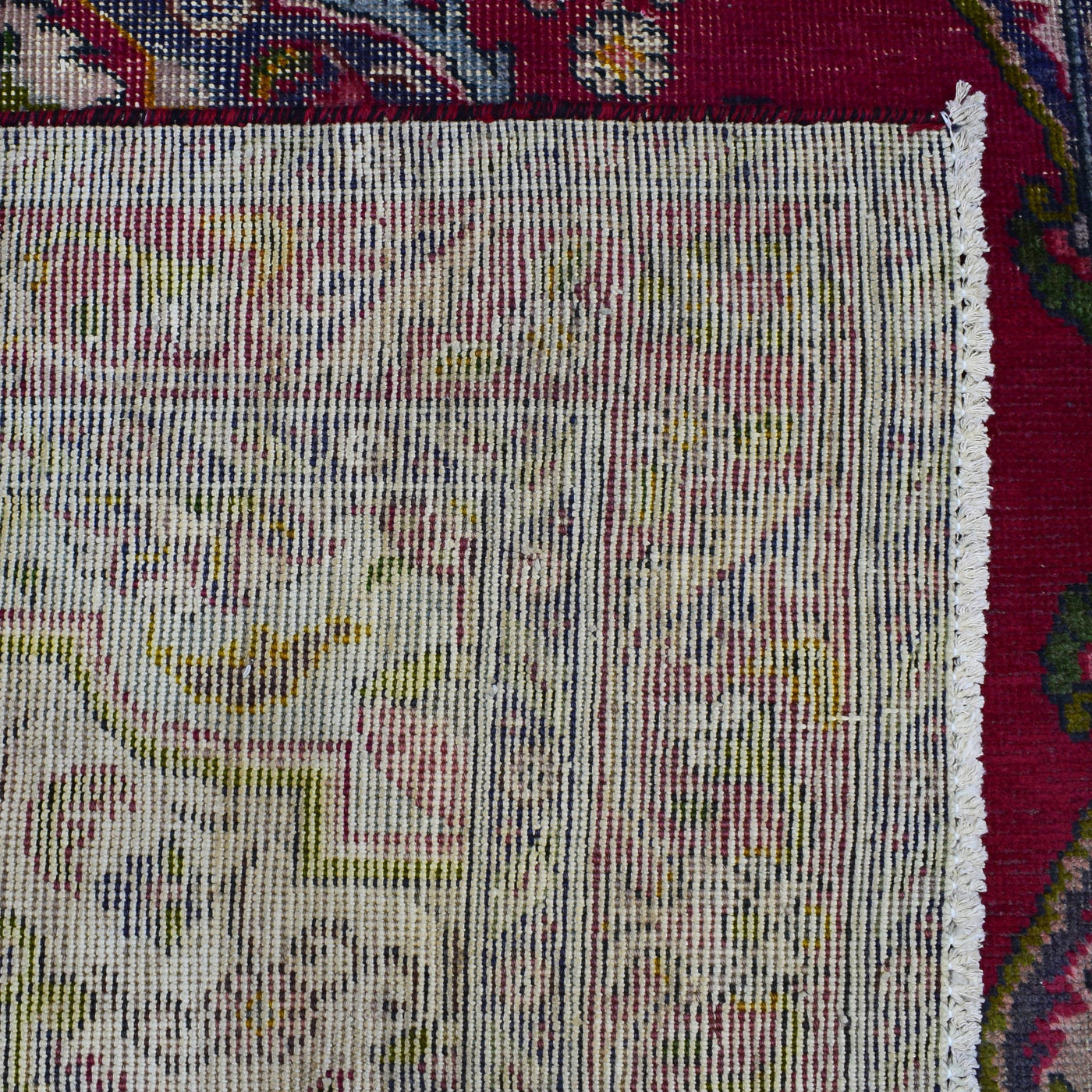 Backside of hand knotted Shiraz rug showing fine weave density and traditional wool foundation