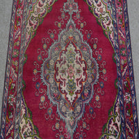 Close-up of central medallion on Shiraz rug with ivory, navy and soft blue floral detailing