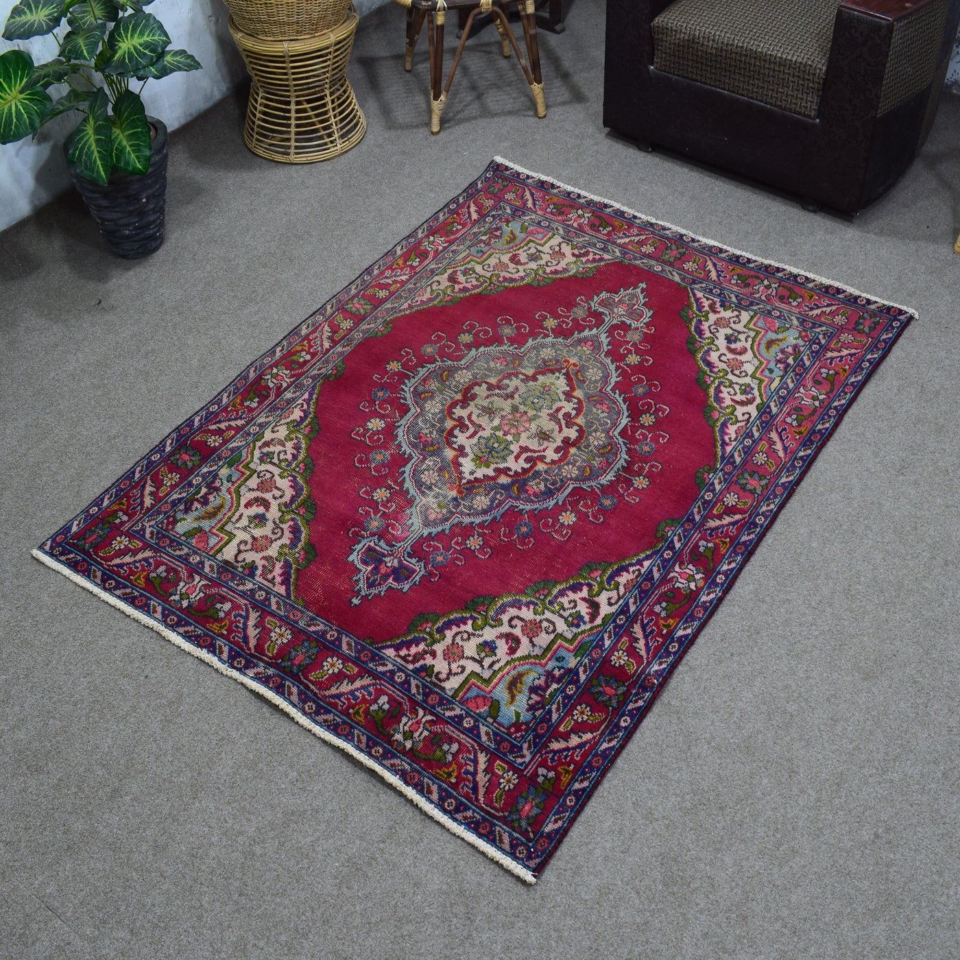 Angled perspective of vintage Shiraz rug highlighting rich red tones and detailed border design