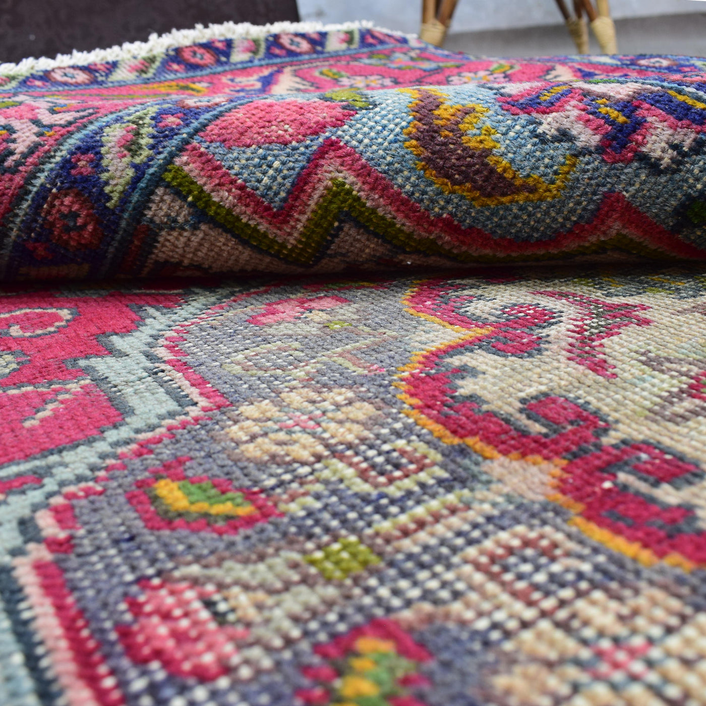 Macro detail of floral motif with crisp pattern definition and multicolored wool