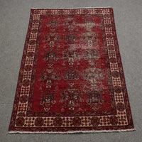 Full length view of Shiraz rug 118x188 cm showing worn red background and subtle geometric medallions
