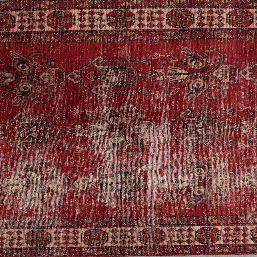 Detailed midsection view of Shiraz rug with weathered pattern and muted ivory accents