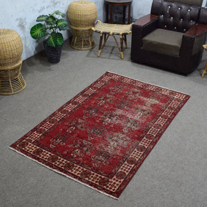 Angled room view of vintage Shiraz rug highlighting distressed finish and soft abrash variation