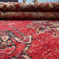 Macro detail of distressed red field with softened pattern definition and color variation
