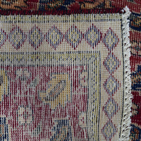 Backside of hand knotted Persian Shiraz rug showing tight weave structure and traditional geometric pattern