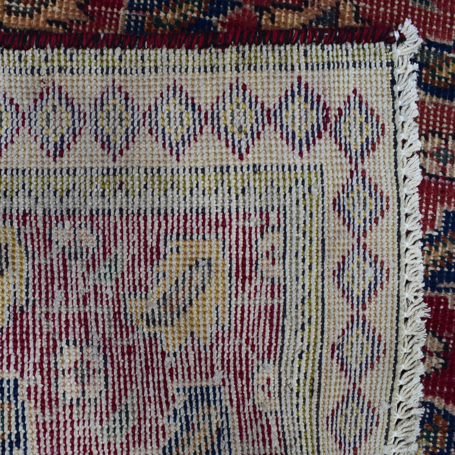 Backside of hand knotted Persian Shiraz rug showing tight weave structure and traditional geometric pattern