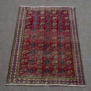 Hand knotted Shiraz Persian rug with repeating geometric tribal motifs on deep red field and narrow patterned borders