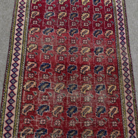 Close view of vintage Shiraz Persian rug showing dense rows of traditional tribal motifs in red, ivory and blue tones
