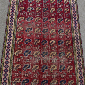 Close view of vintage Shiraz Persian rug showing dense rows of traditional tribal motifs in red, ivory and blue tones