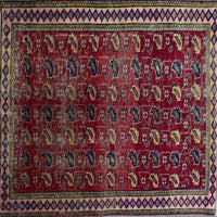 Detailed field of vintage Persian Shiraz rug featuring repeating stylized tribal motifs on rich red background