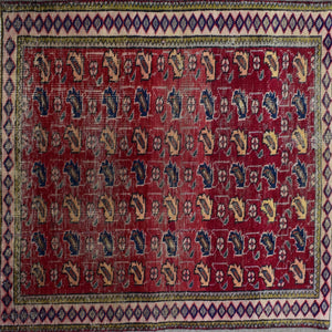 Detailed field of vintage Persian Shiraz rug featuring repeating stylized tribal motifs on rich red background