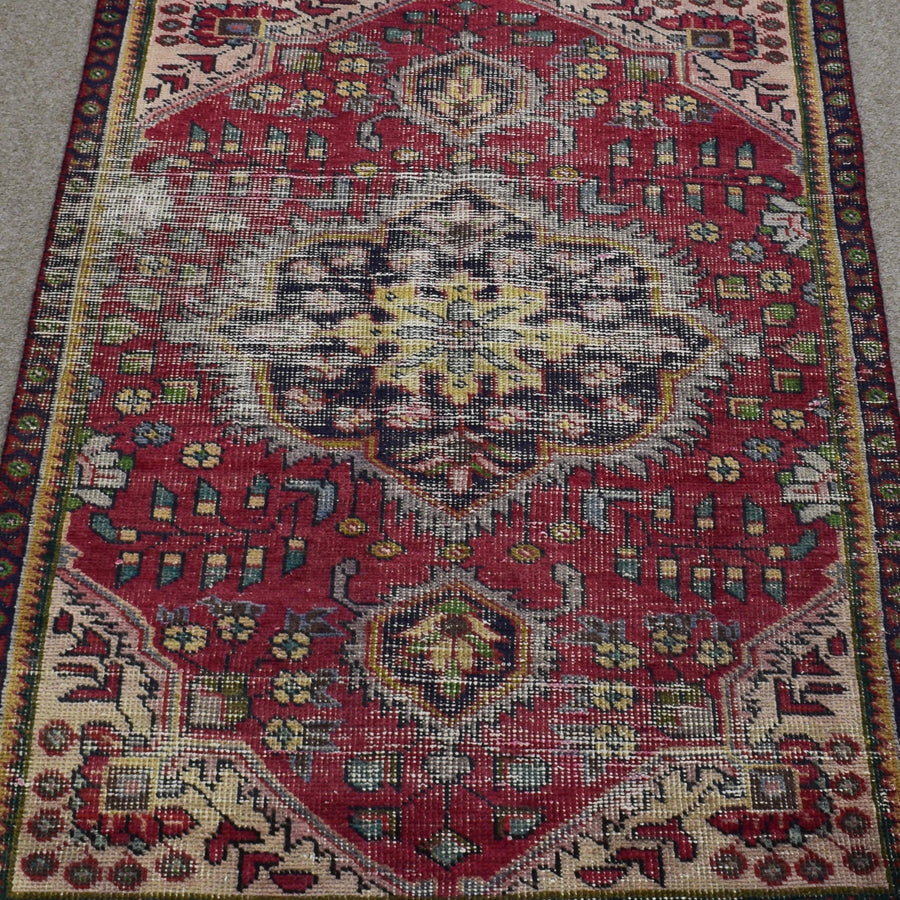 Detailed view of Shiraz Persian rug with ornate central medallion surrounded by small geometric tribal motifs