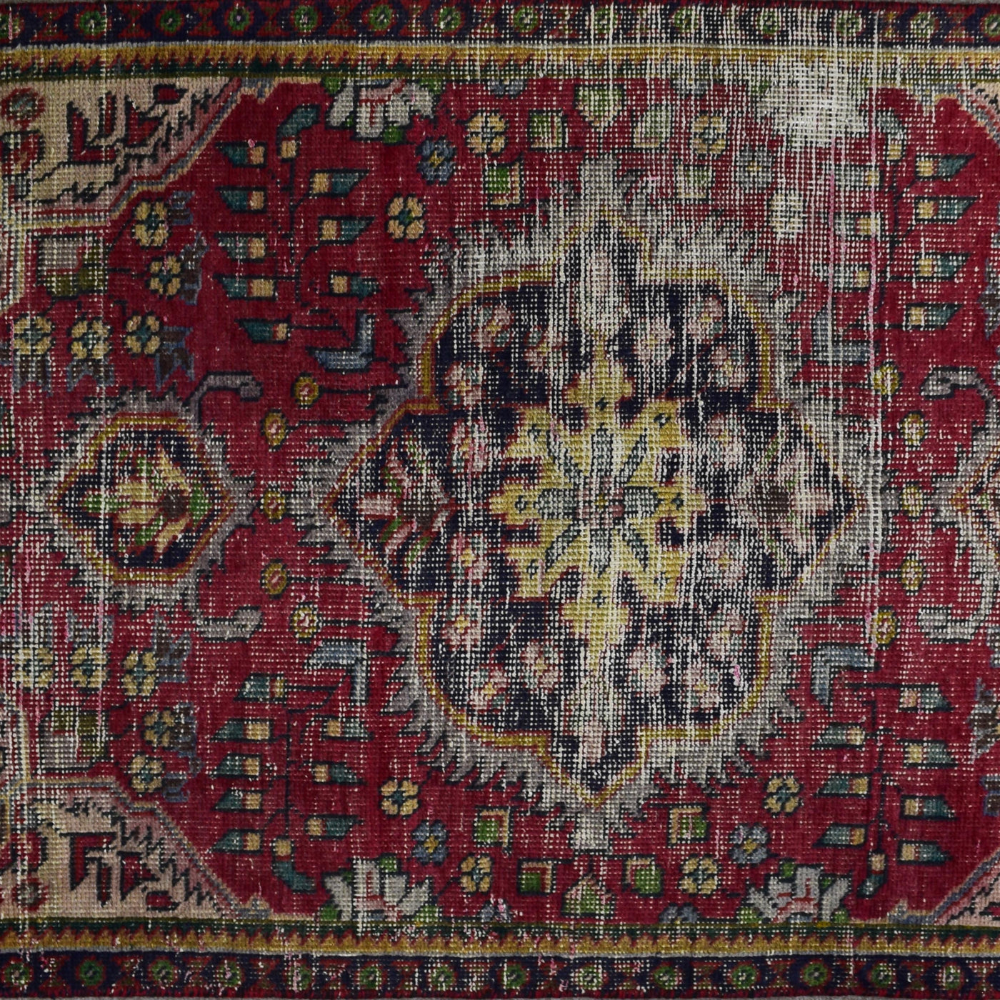 Close up of vintage Persian Shiraz rug medallion showing intricate geometric patterns in ivory, blue and red tones
