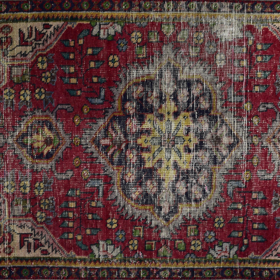 Close up of vintage Persian Shiraz rug medallion showing intricate geometric patterns in ivory, blue and red tones
